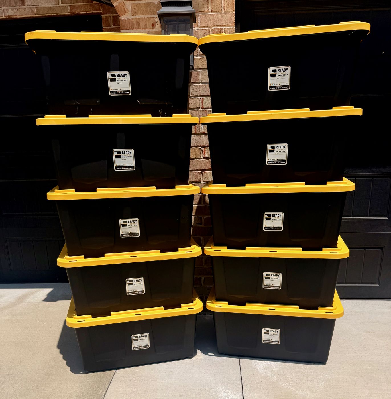 Ten Ready Tote Oklahoma bins stacked in a driveway
